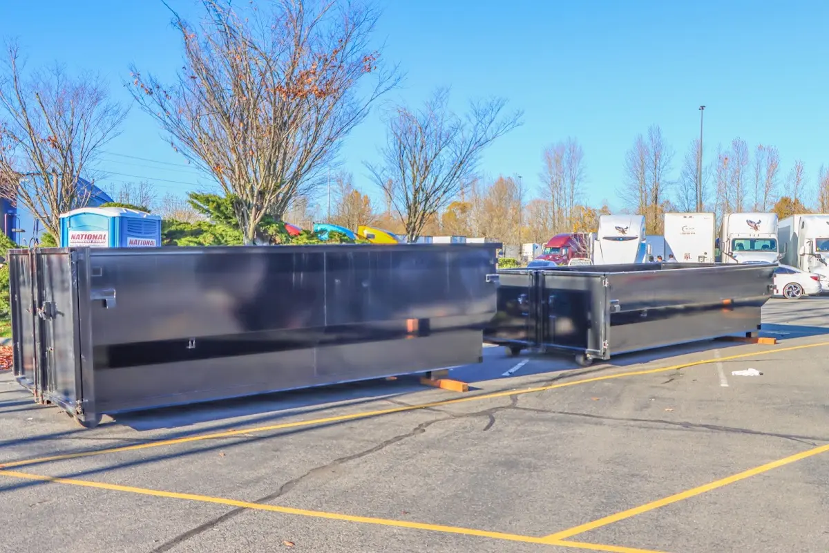 Professional dumpster rental service with roll-off container on residential driveway in Pacific